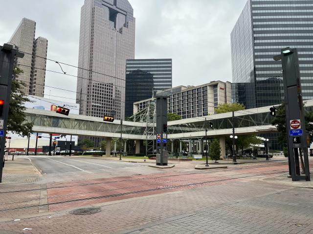 An American highway intersection with bridges between skyscrapers above the road