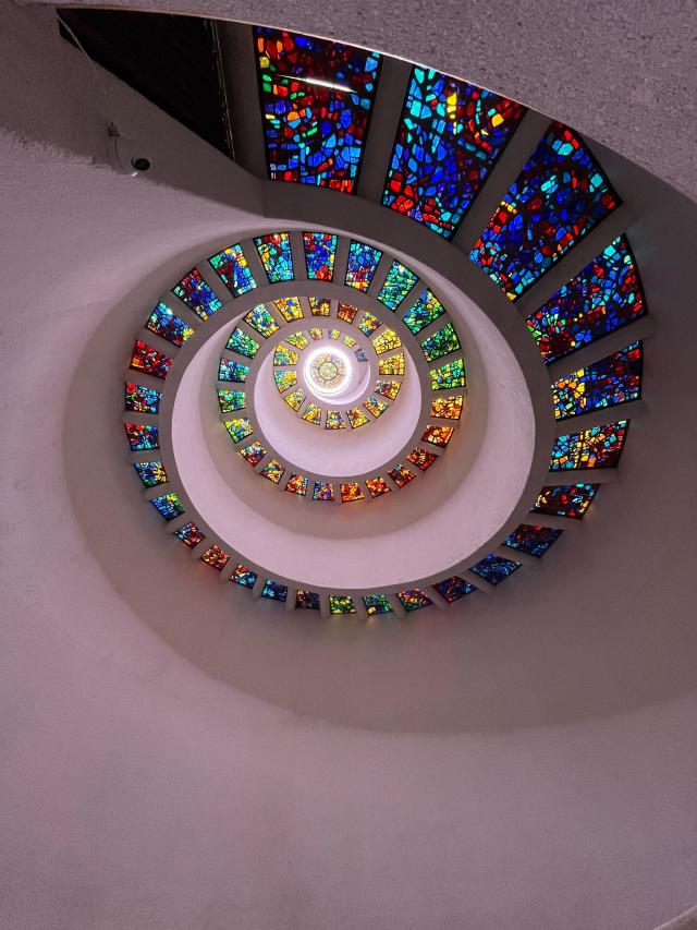 A spiral stained glass roof going upwards in height